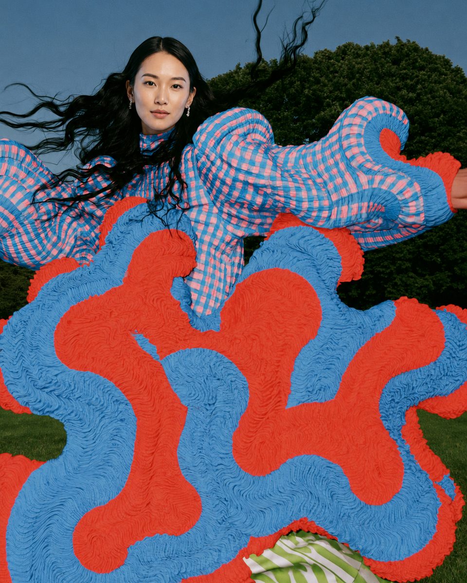 Red-and-blue gingham knit look, dancing in a field